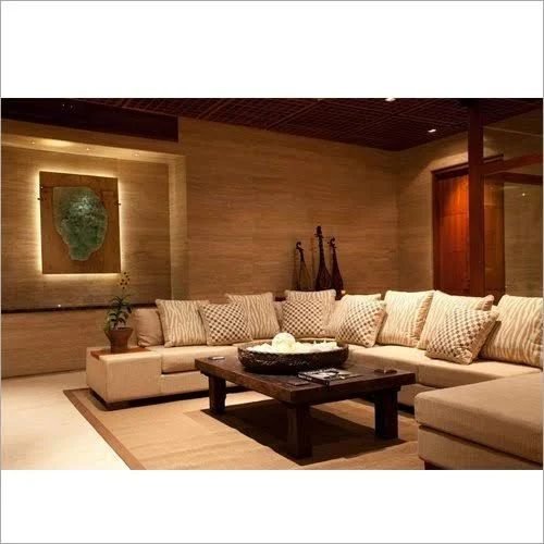 Living room with a beige sectional, timber panelling and a low centre table
